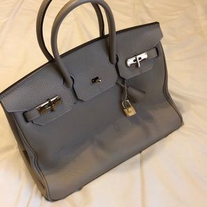 Grey purse with gold buckles